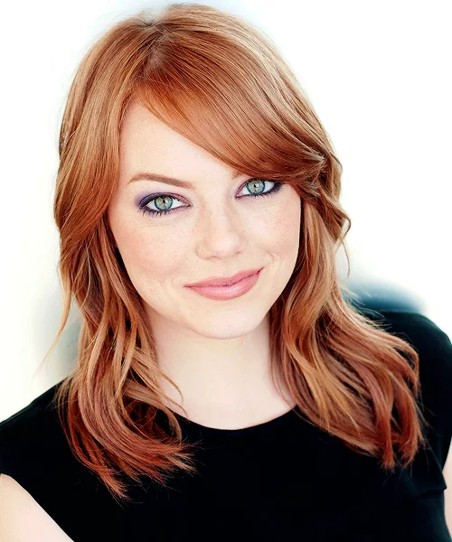 Portrait of Emma Stone with red hair and green eyes smiling softly