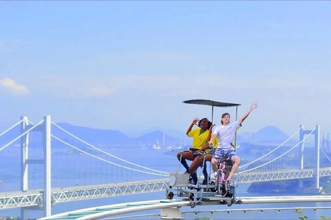Enoden Bicycle Bro — Photoshop of bicycle bro and friend on canopied tandem bike on a bridge over the sea