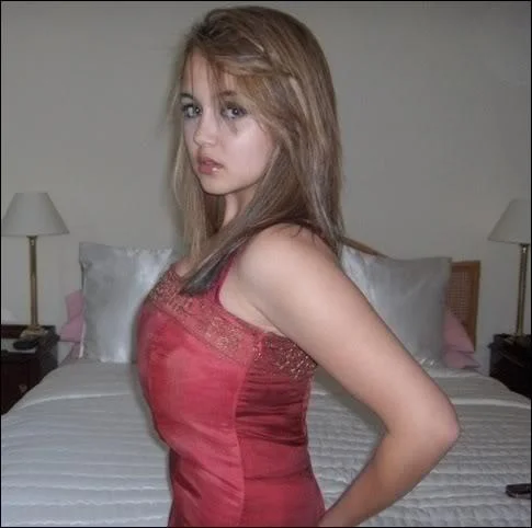 Epic Boobs Girl — Young woman in red dress posing in a bedroom