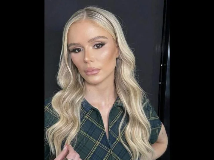 Erin Moriarty Plastic Surgery — Erin Moriarty selfie with platinum blonde hair and green plaid top