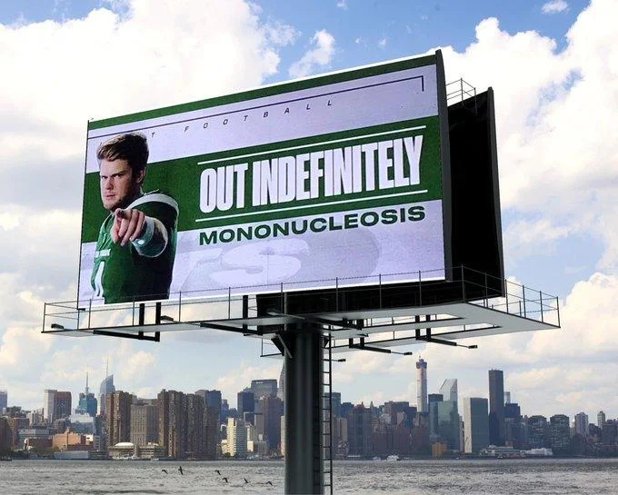 ESPN's "Sam Darnold: Out Indefinitely" Graphic — Photoshopped billboard displaying the ESPN Sam Darnold mononucleosis graphic over a city skyline