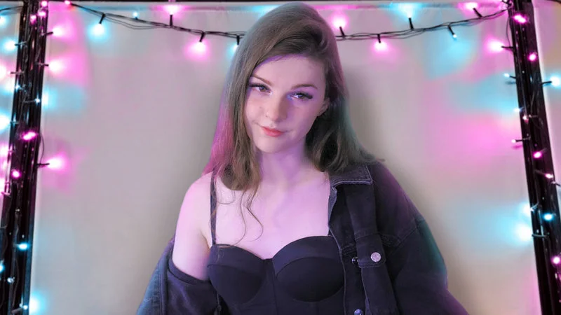 F1Nn5Ter Coming Out Video — Stream frame of F1NNSTER against pink and blue neon light backdrop.