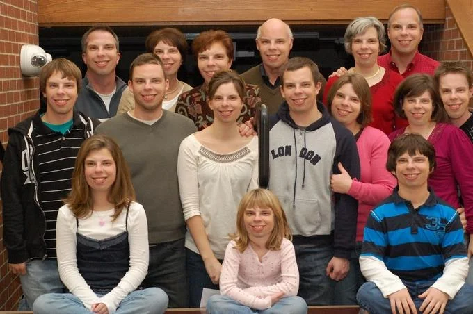 Facebomb — Large family group posed on stairs with several members appearing to share similar facial features
