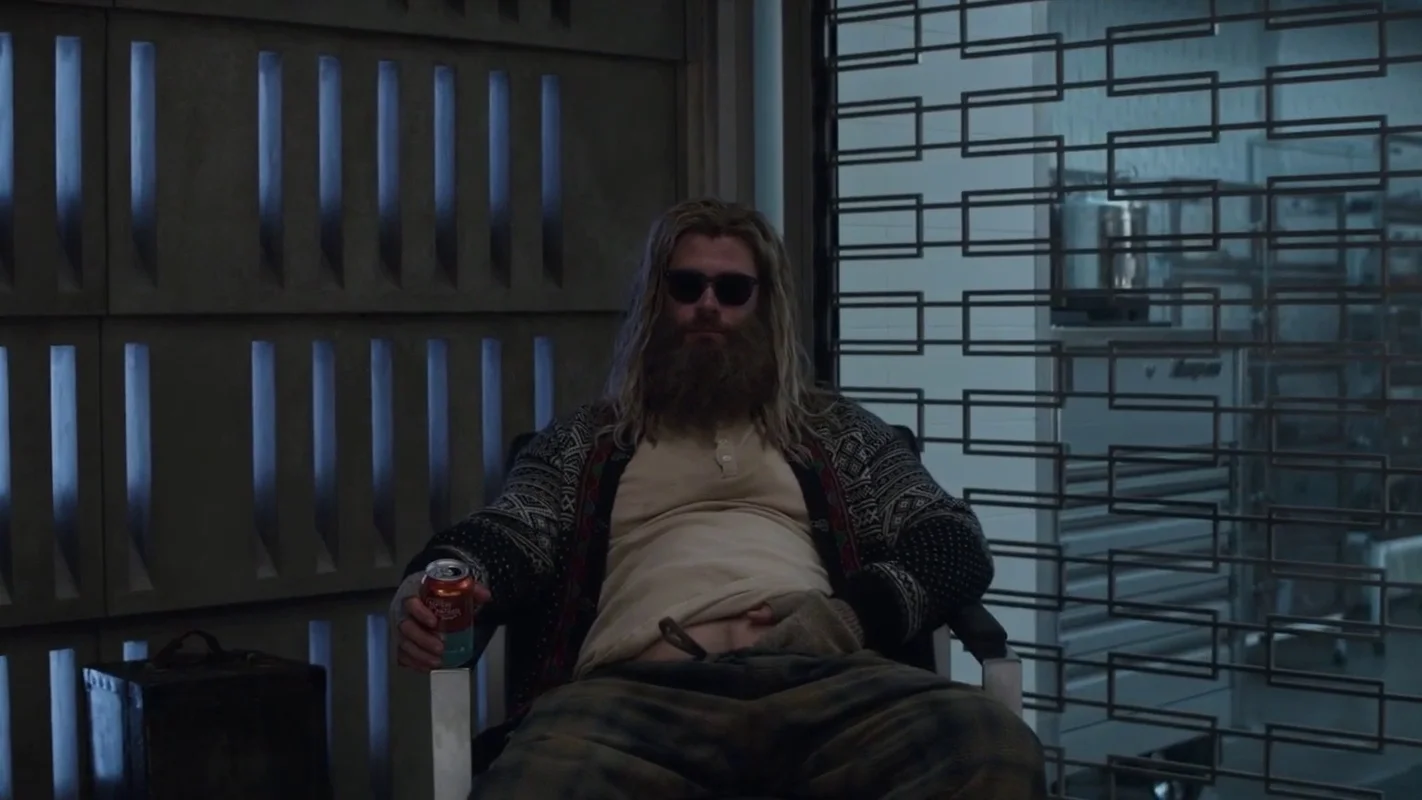 Fat Thor — Thor from Avengers: Endgame with long hair, beard, sunglasses and a beer belly slouched in a chair