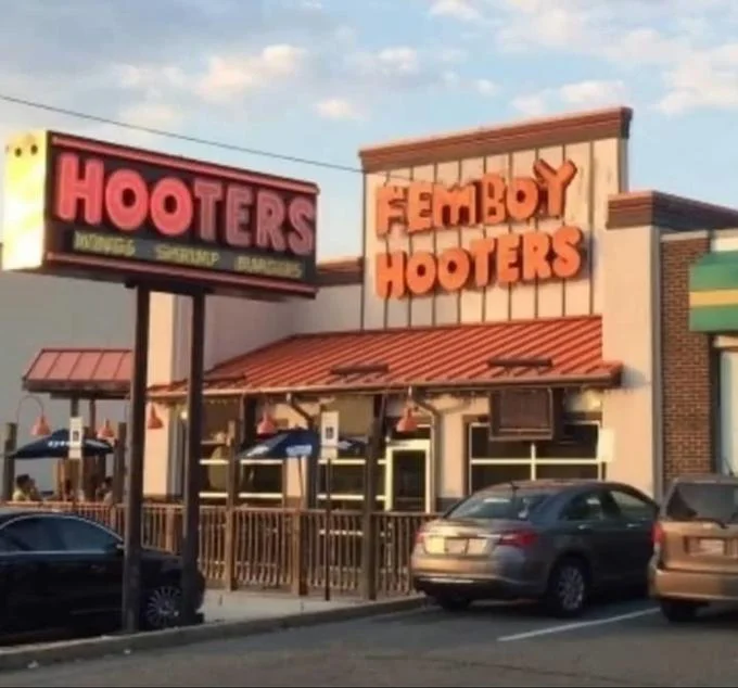 Real Hooters restaurant with 'Femboy Hooters' sign in bright orange lettering