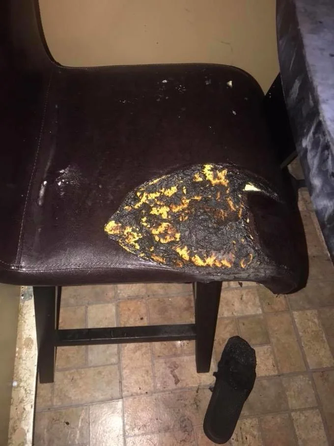 Burned leather chair with melted seat and charred slipper on floor after Fire Challenge accident