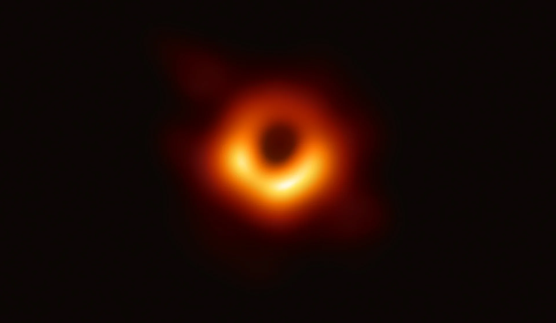 First Image Of Black Hole — First image of a black hole showing a bright orange ring around a dark center in space