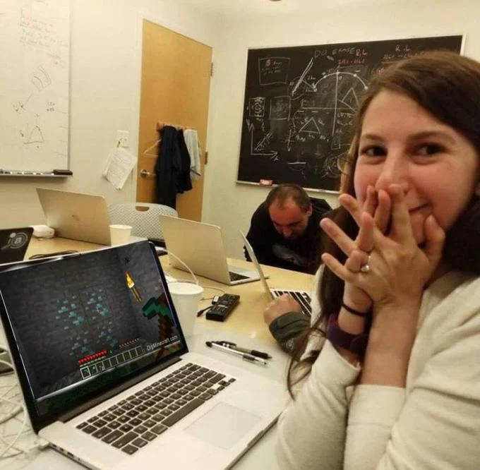 First Image Of Black Hole — Edited Katie Bouman photo with Minecraft gameplay shown on her laptop instead of the black hole
