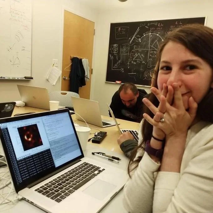 First Image Of Black Hole — Katie Bouman covering her mouth in excitement as the first black hole image loads on her laptop