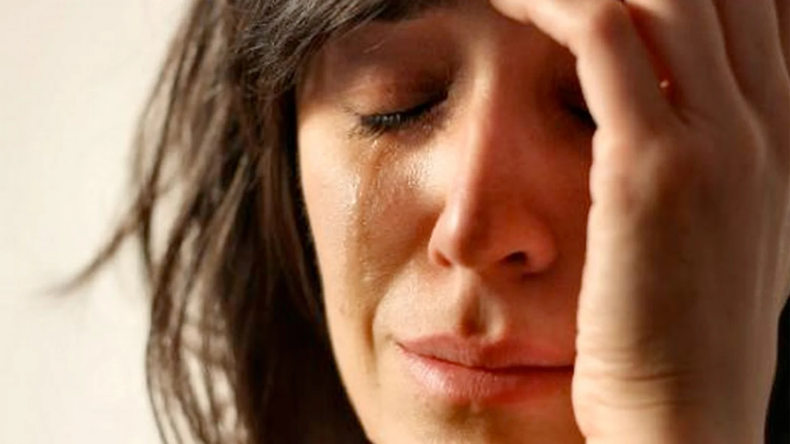 First World Problems — Woman with hand to face in distressed expression.