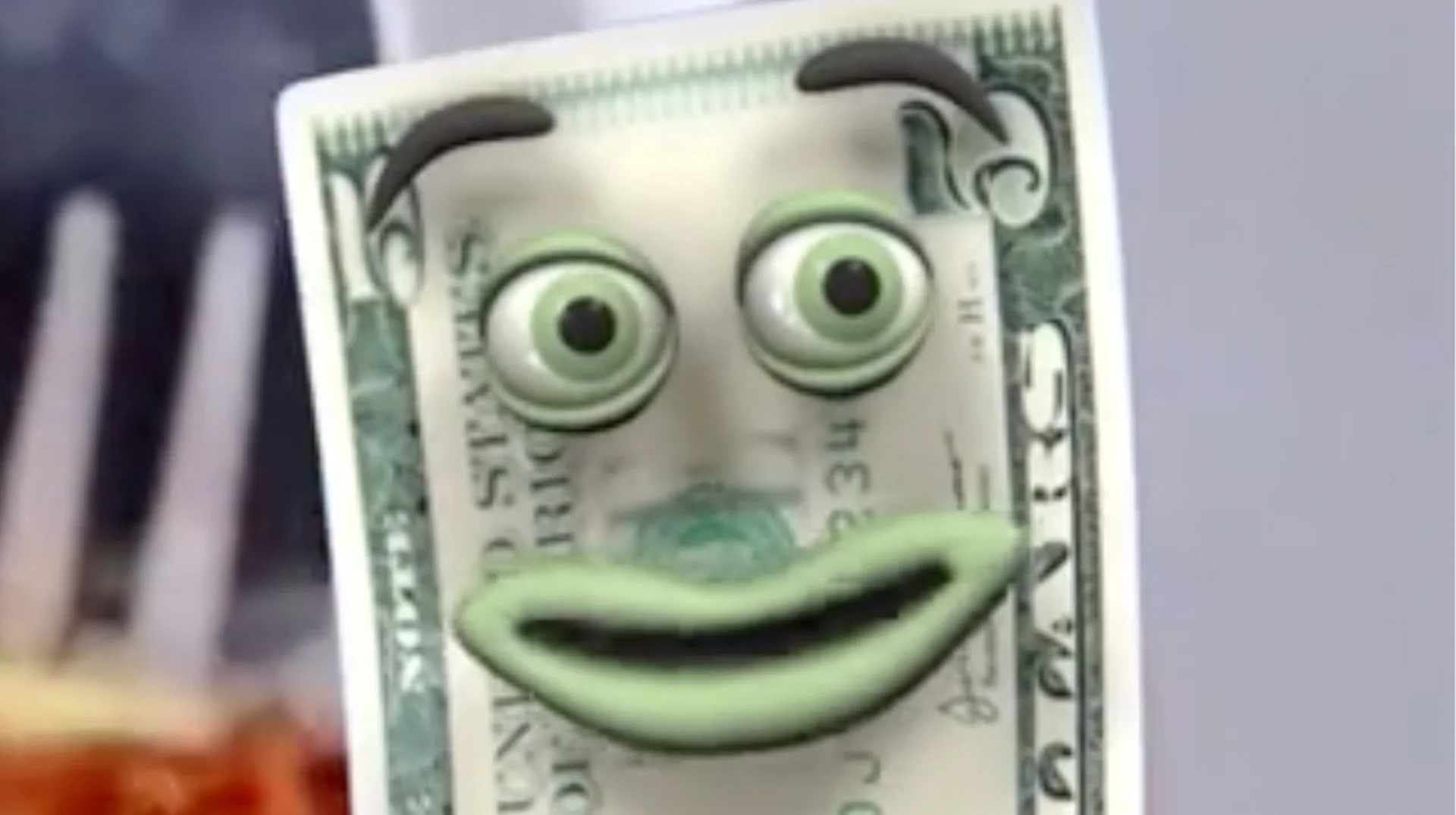 Fiveish Yap Dollar — Close-up of Fiveish, an animated five-dollar bill character with green eyes and a wide green smile.