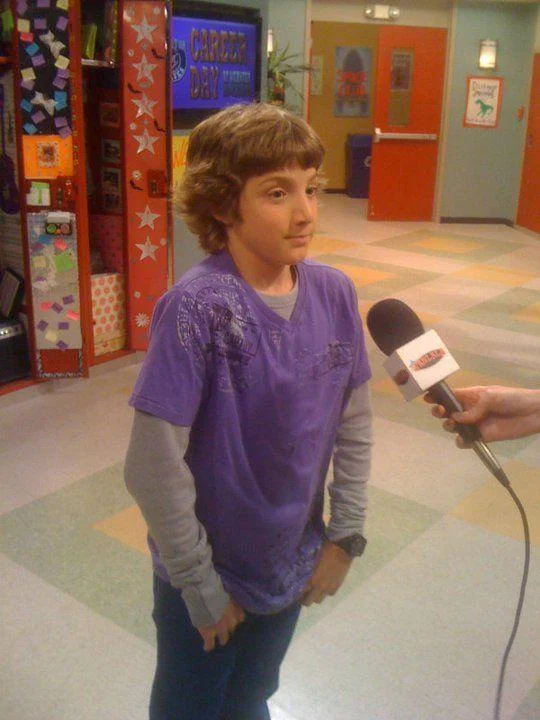 Fletcher Quimby Getting Interviewed — Fletcher Quimby in purple shirt being interviewed with a FanLala microphone