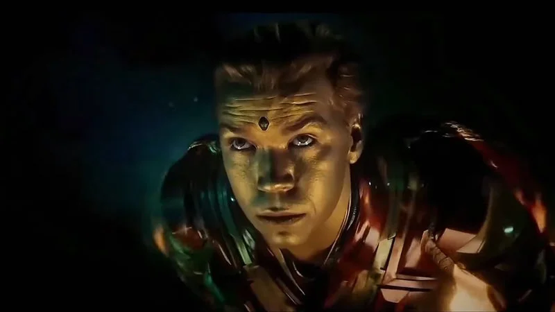 Flying Adam Warlock — Close-up of Adam Warlock with gold makeup flying toward camera.
