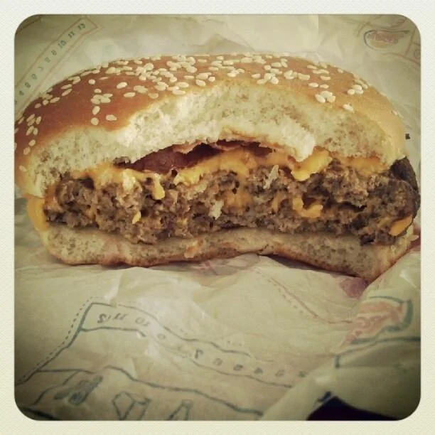 Food Porn — Close-up of Burger King cheeseburger cut in half with vintage filter.