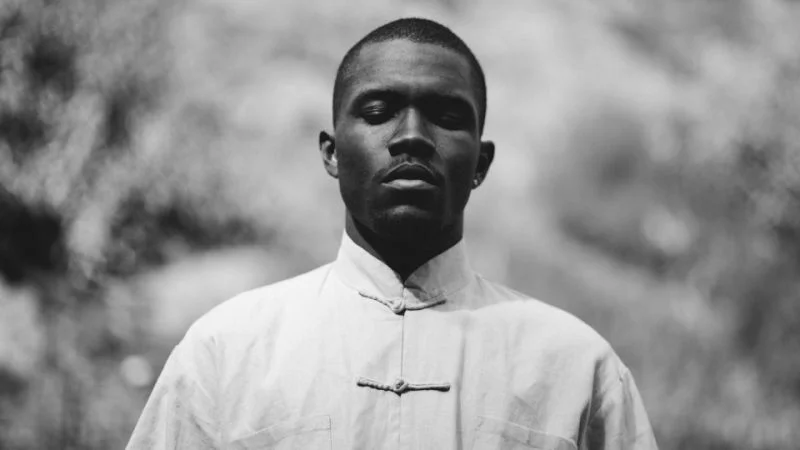 Black-and-white portrait of Frank Ocean in a light mandarin-collar shirt