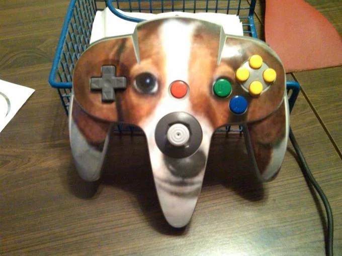 Nintendo 64 controller with a FrankerZ dog face skin in a wire basket