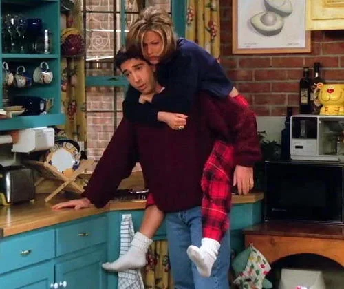Friends — Ross giving Rachel a piggyback ride in Monica's kitchen
