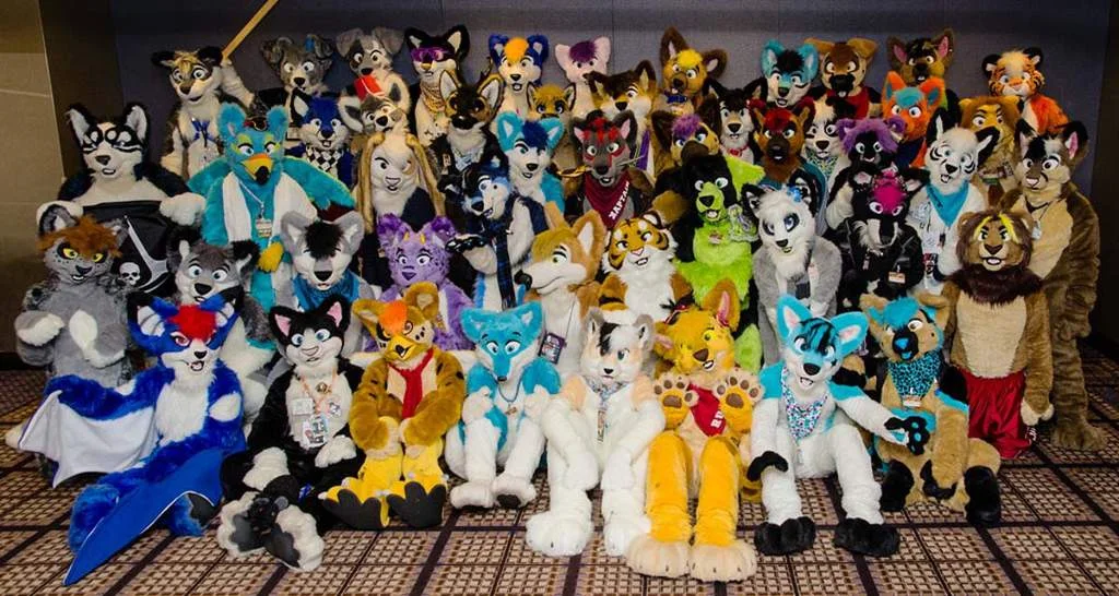 Furries — Group of furry fandom members in colorful animal fursuits posing at a convention