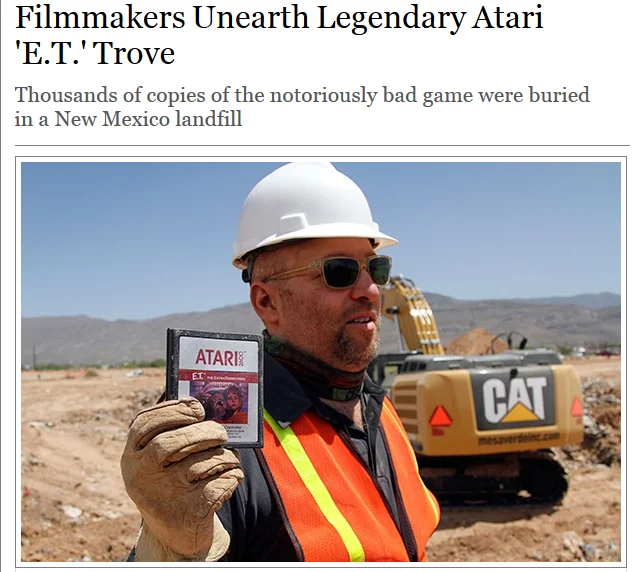 Gaming — News screenshot of a worker holding an unearthed Atari E.T. cartridge at a landfill dig