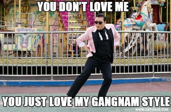 PSY performing Gangnam Style at an amusement park with Impact text 'YOU DON'T LOVE ME / YOU JUST LOVE MY GANGNAM STYLE.'