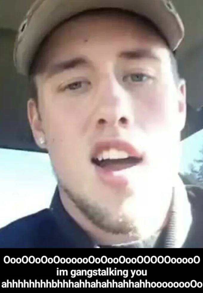 Young man in cap with caption 'im gangstalking you' and nonsense vowels