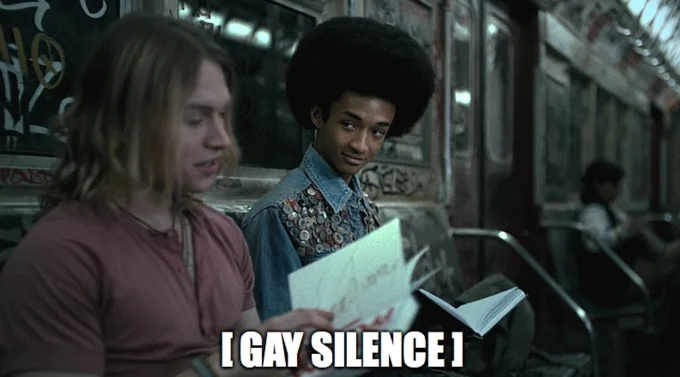 A scene with two people from film or television with '[I GAY SILENCE]' text in large white capital letters.