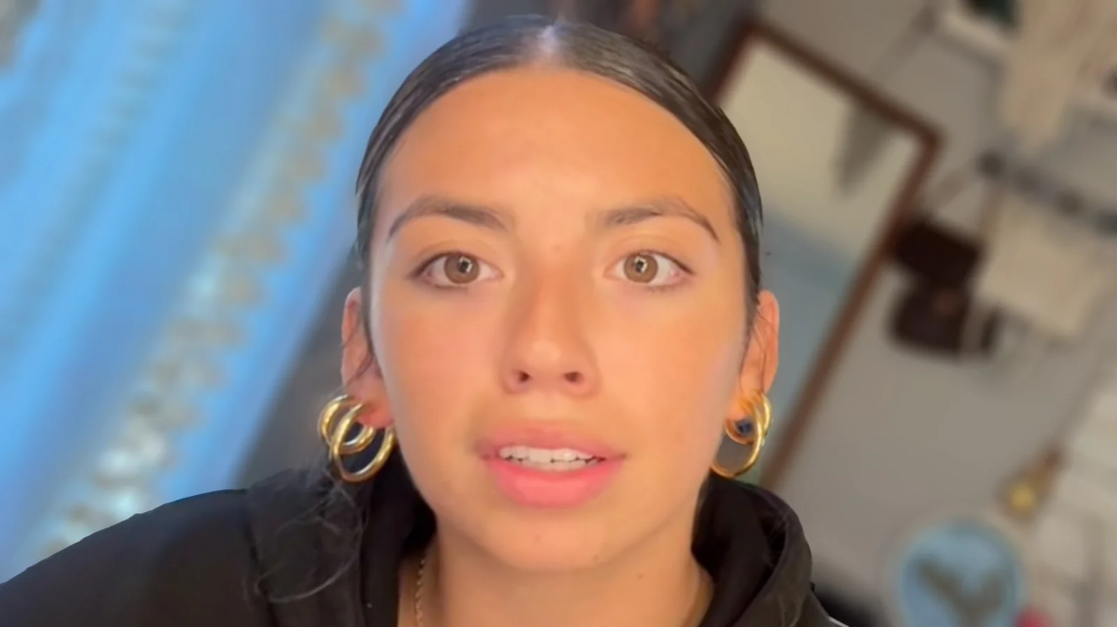 A young person stares directly at the camera with a blank, unflinching expression embodying the Gen Z Stare aesthetic.