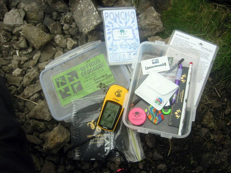 Geocaching — Yorkshire Dales geocache contents with GPS, swag, and logbook