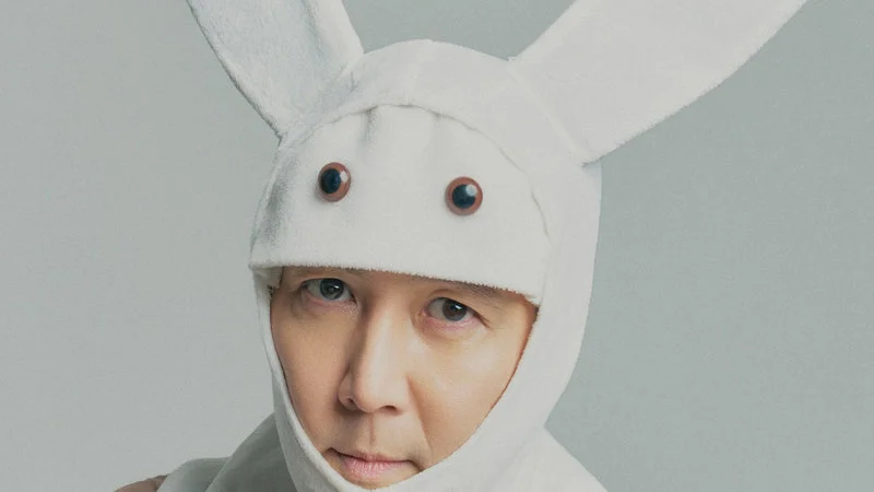Gi Hun Bunny — Professional studio headshot of Lee Jung-jae in white bunny costume with oversized ears and cartoonish eye design.