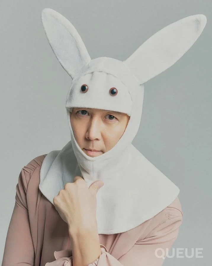 Gi Hun Bunny — Professional studio photograph of Lee Jung-jae in white bunny costume shown from shoulders up with beige shirt underneath.