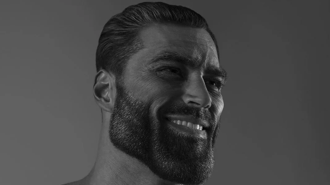Gigachad — Head and shoulder portrait of muscular man with strong facial features and confident smirk exemplifying idealized masculinity.