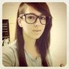 Girls That Look Like Skrillex — Close-up portrait of woman with glasses displaying Skrillex-inspired hairstyle with one side shaved.