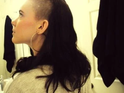 Girls That Look Like Skrillex — Profile photograph of woman with signature Skrillex-inspired hairstyle, one side shaved with long hair on opposite side.