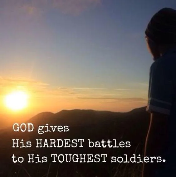 God Gives His Hardest Battles To His Strongest Soldiers — Person silhouetted against golden sunset over mountains with motivational phrase overlaid in white