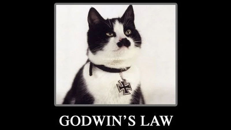 Black and white cat wearing Nazi symbol collar with 'GODWIN'S LAW' text, definitive visual meme representation.