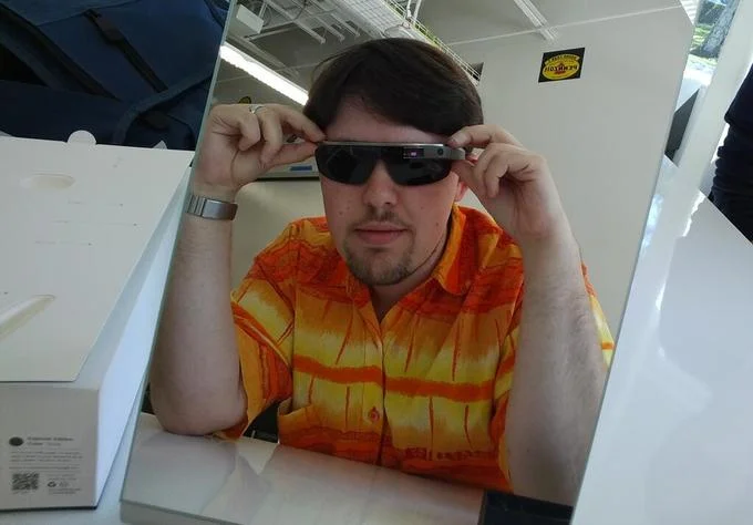 Man trying on Google Glass with shade lenses at a fitting station