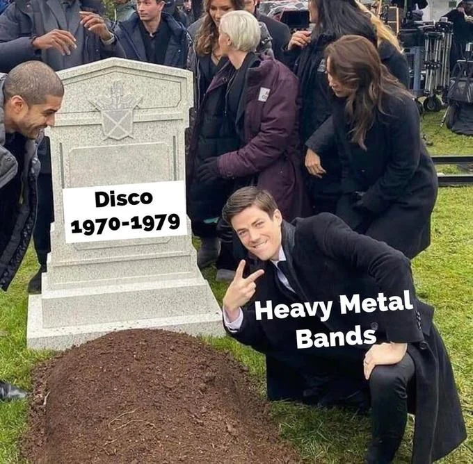 Grant Gustin Next To Oliver Queens Grave — Grant Gustin next to grave labeled 'Disco 1970-1979' with heavy metal caption.