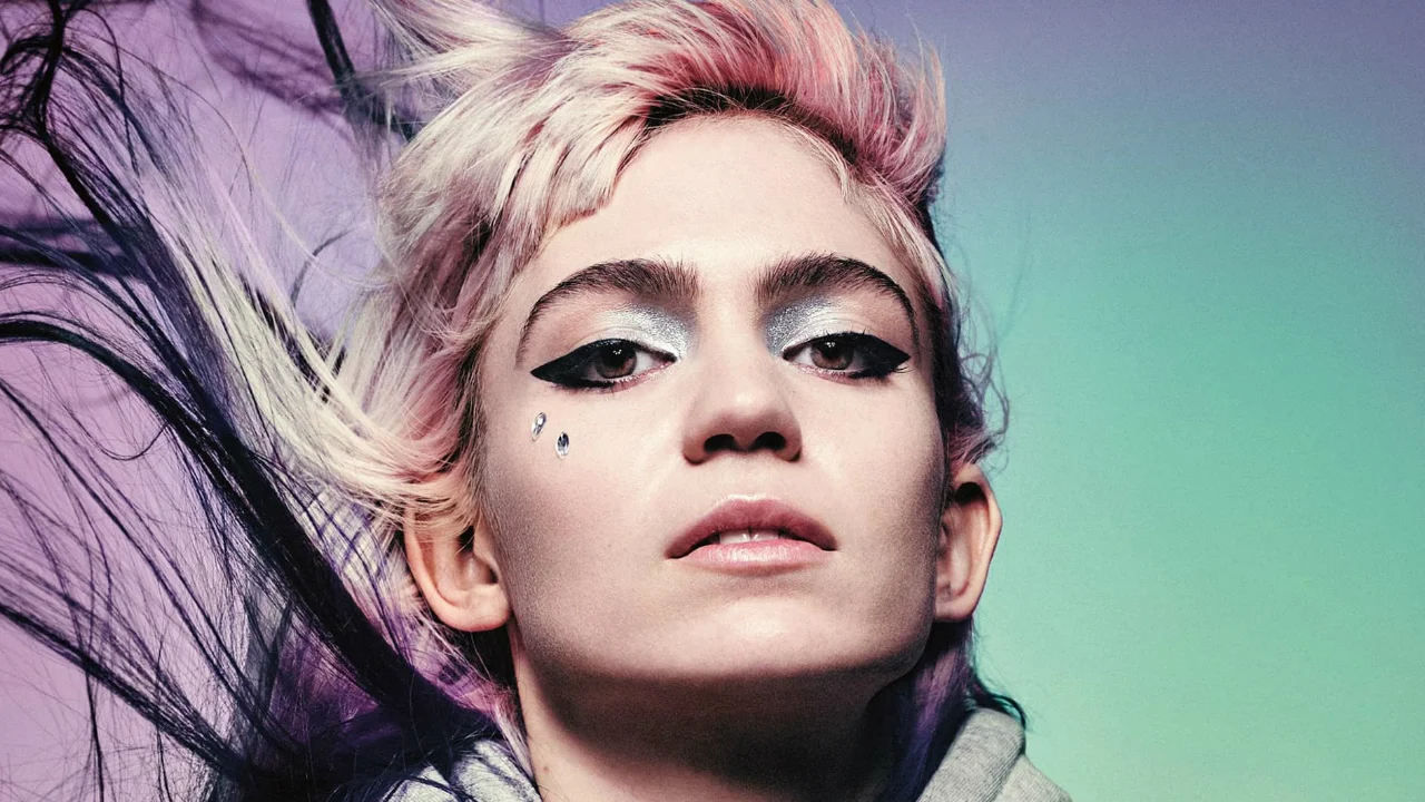 Close-up portrait of Grimes with pink-blonde hair and glittery silver eye makeup