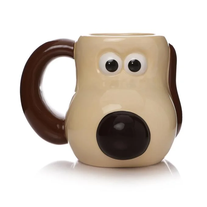 Professional product photograph of Gromit Mug with sharp focus showing cream ceramic with large black eyes and mouth.