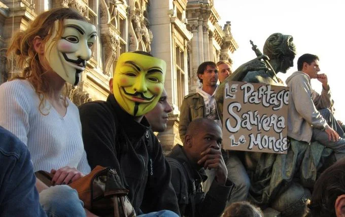 Two Guy Fawkes masked protesters at a demonstration in Paris
