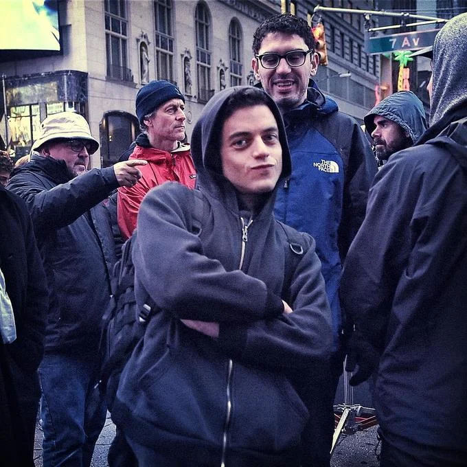Hackerman — Rami Malek in hoodie on Mr. Robot NYC set surrounded by film crew