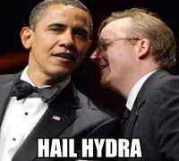 A photograph of President Barack Obama in a tuxedo leaning in to speak with another man at a formal function, captioned 'HAIL HYDRA'.