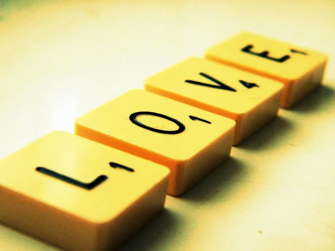 Hasbro — Scrabble tiles arranged to spell the word LOVE