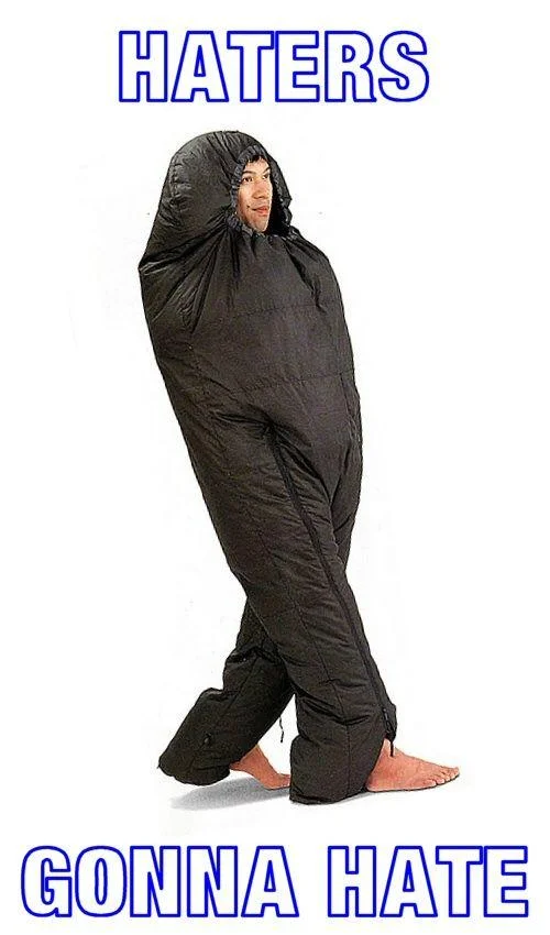 Person wearing a full-body sleeping bag suit with 'Haters gonna hate' caption
