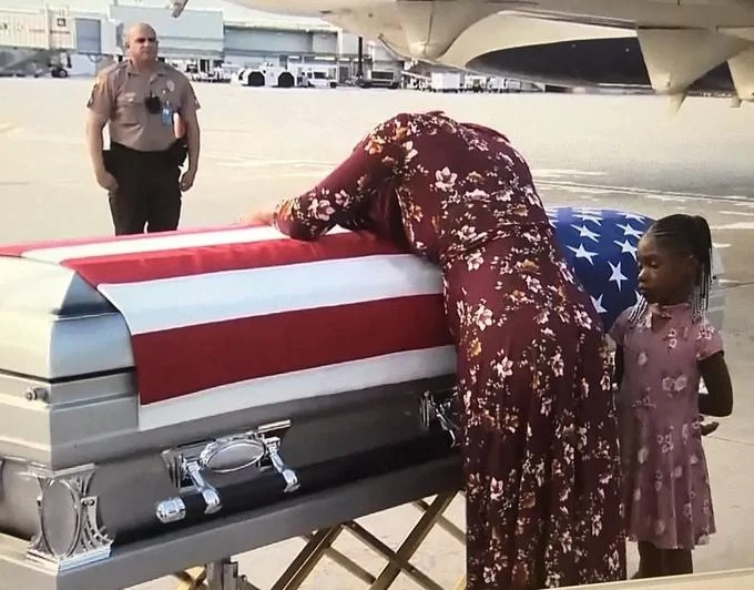 "He Knew What He Signed Up For" — Myeshia Johnson mourns over the flag-draped casket of Sgt. La David Johnson with her daughter
