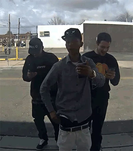 Animated GIF of three men dancing and checking phones in front of the He Will Not Divide Us livestream camera