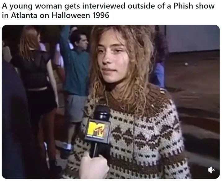 Hippie Chick Interviewed at a Phish Show — Captioned video still of the woman holding an MTV microphone outside a Phish show in Atlanta on Halloween 1996.