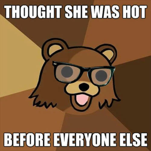 Comic-style cartoon bear wearing thick black-framed hipster glasses on geometric radial background with mockingly hipster caption.