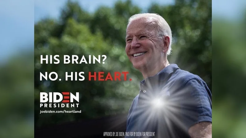 Joe Biden smiling in a blue polo shirt with campaign text reading 'His brain? No. His heart.' and the Biden President logo.