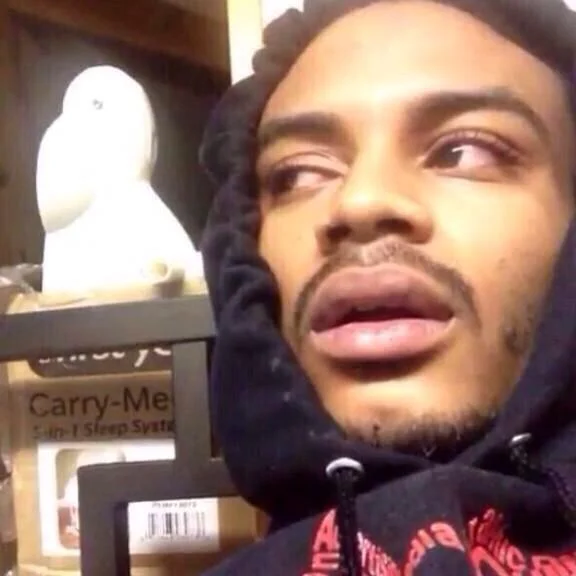 *Hits Blunt* — Man in black hoodie with red, heavy-lidded eyes giving a stoned stare in a store aisle